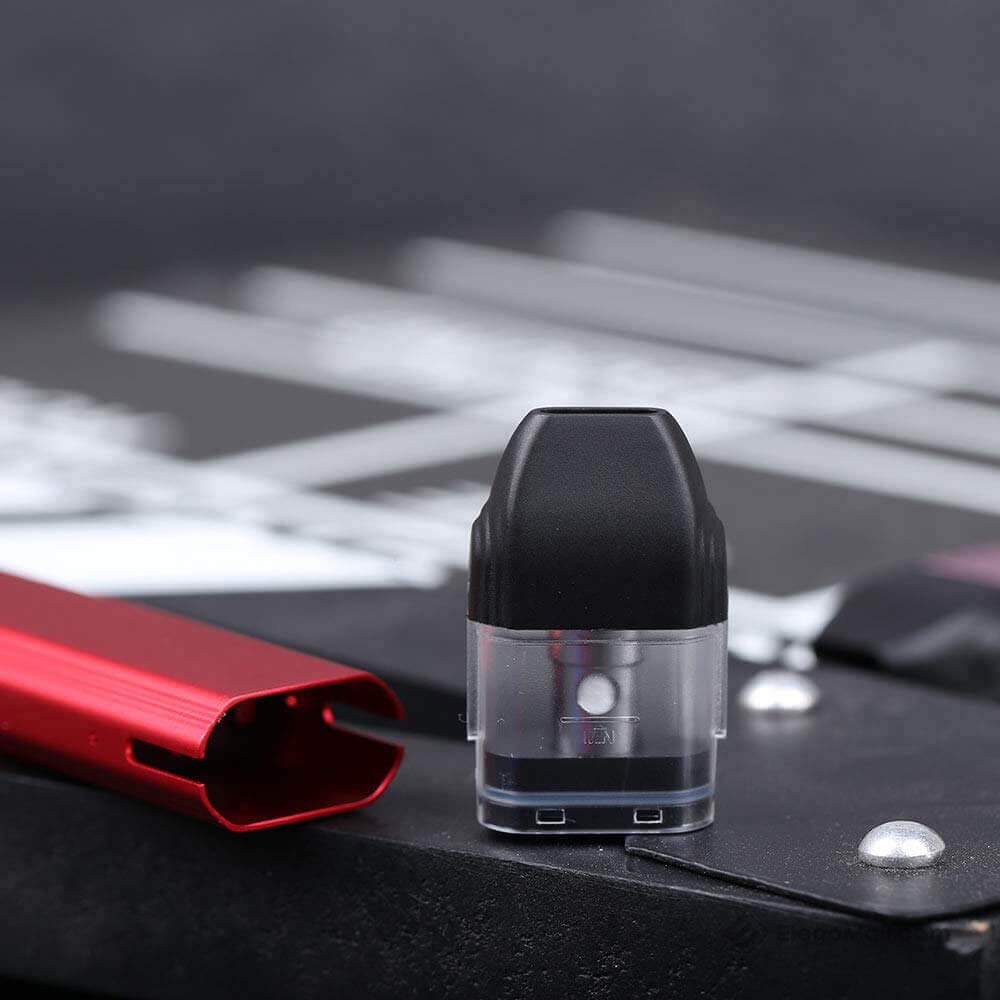 Uwell Caliburn replacement pod shown next to a partial red Caliburn device