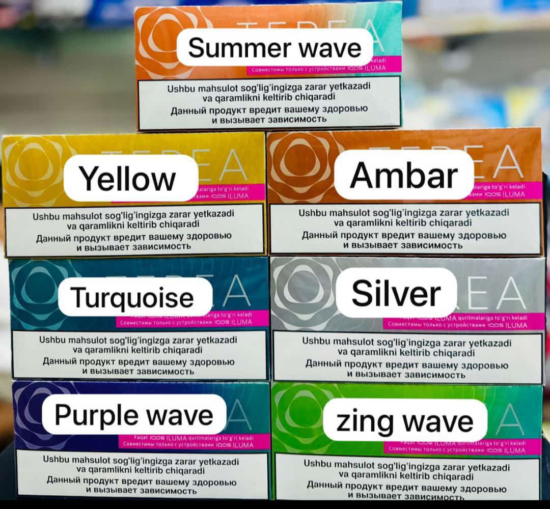 Close-up of an IQOS Iluma device with an inserted Terea Uzbekistan stick, ready for use.