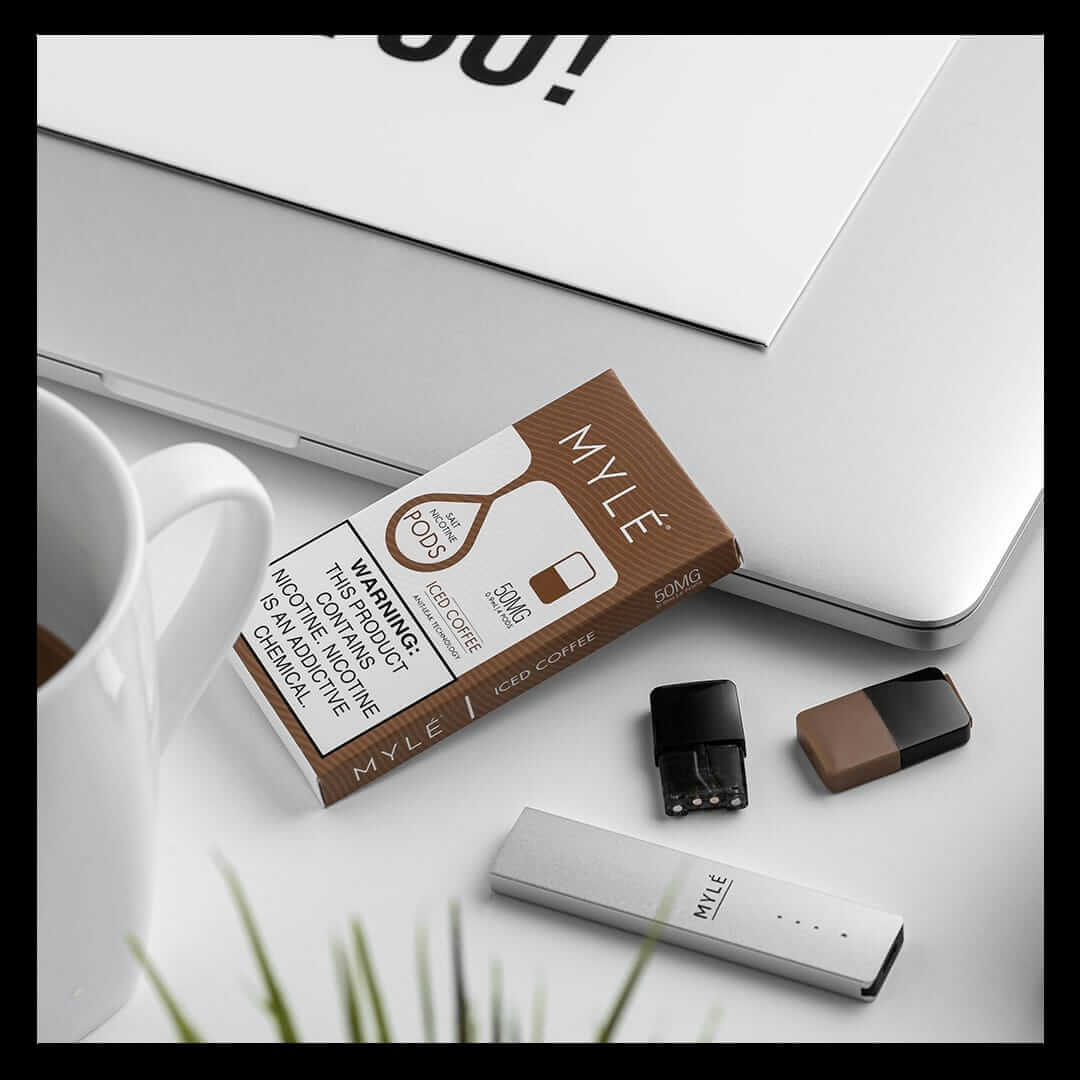 MYLÉ Iced Coffee 50mg pods with device and pods on desk.
